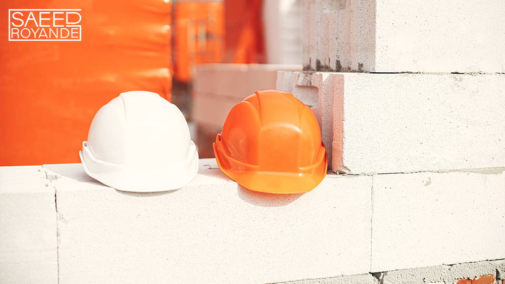 Safety helmets on masonry white blocks architectu