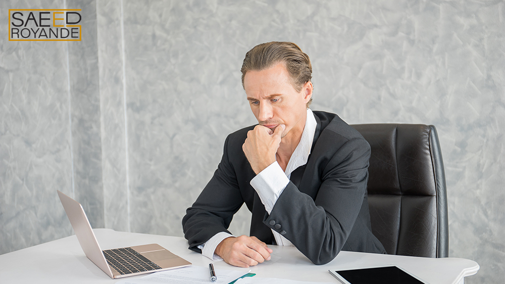 Serious businessman stressed out at work in office