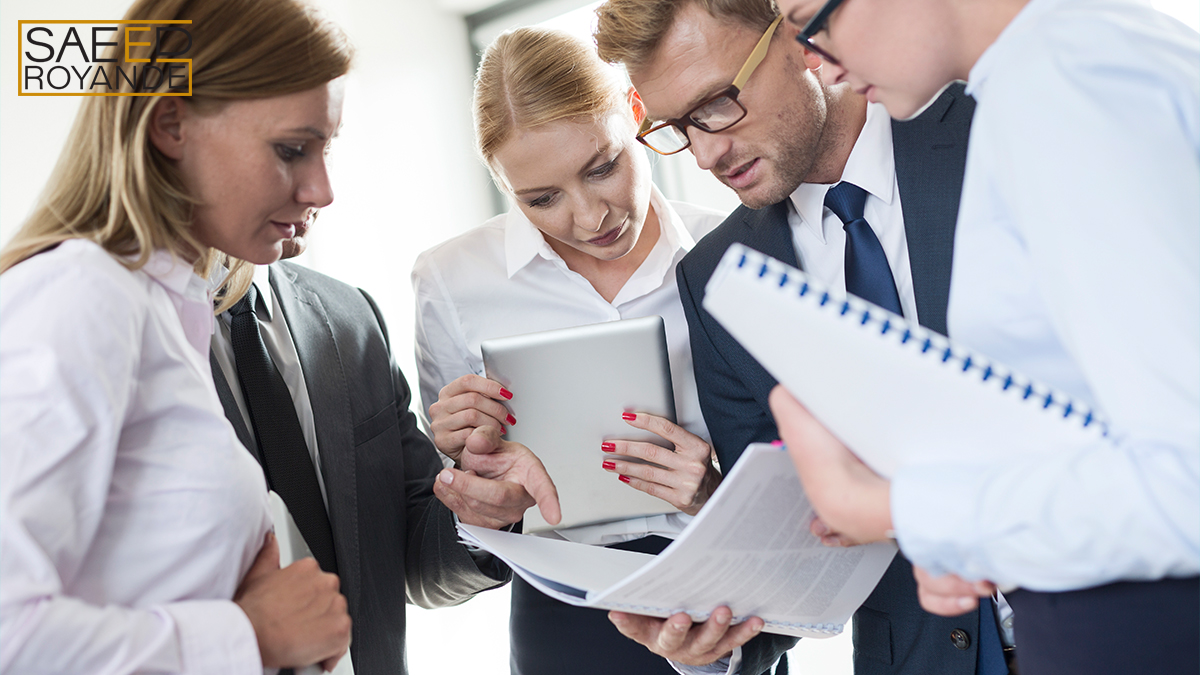 Business people reading in booklet