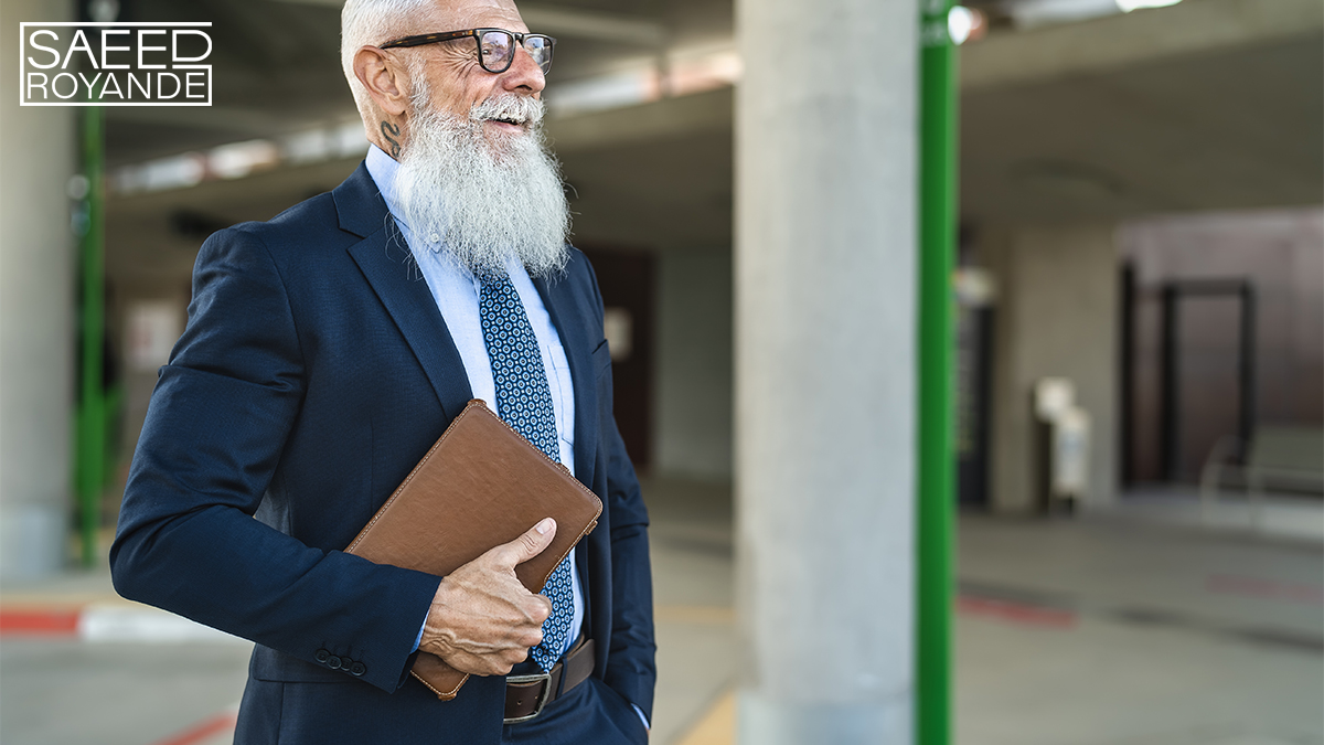 Happy senior business man holding digital tablet