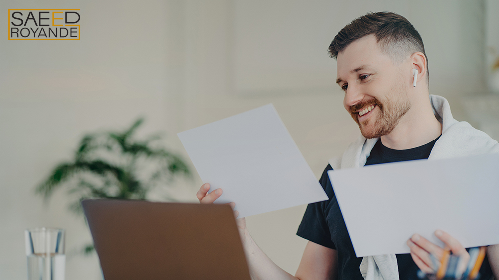 Happy entrepreneur looking at documents