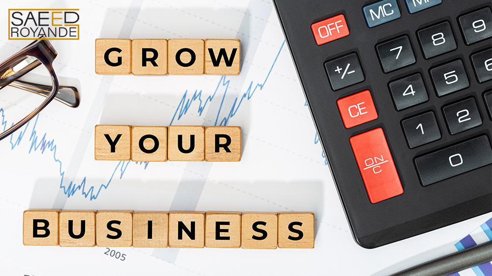 Grow your business letter cube beside calculator