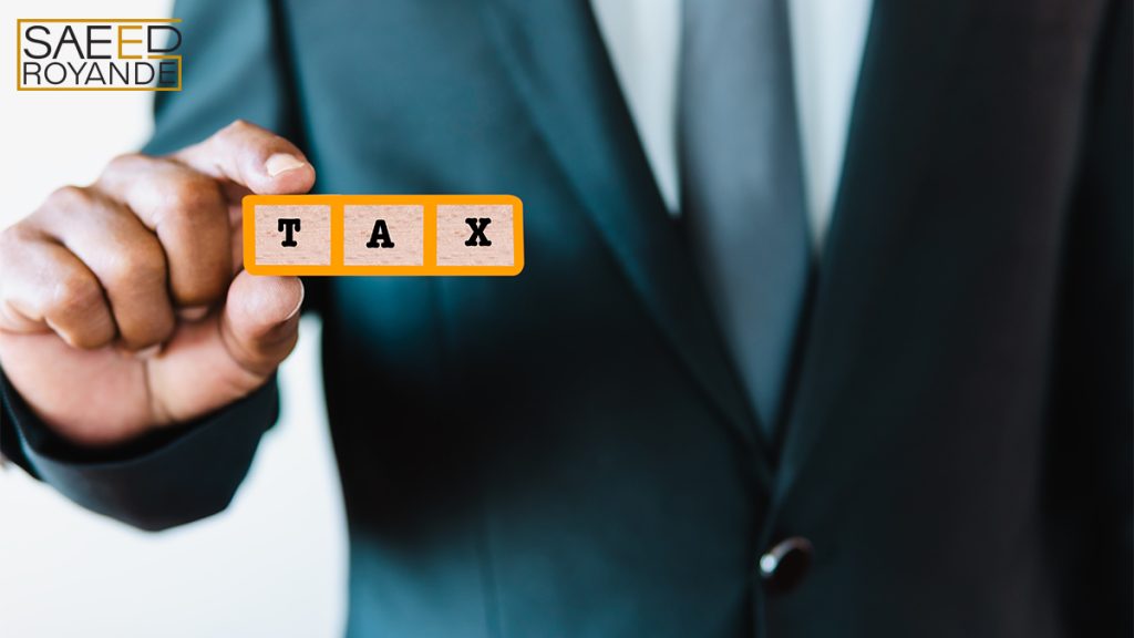 Business man holding tax text sign for present