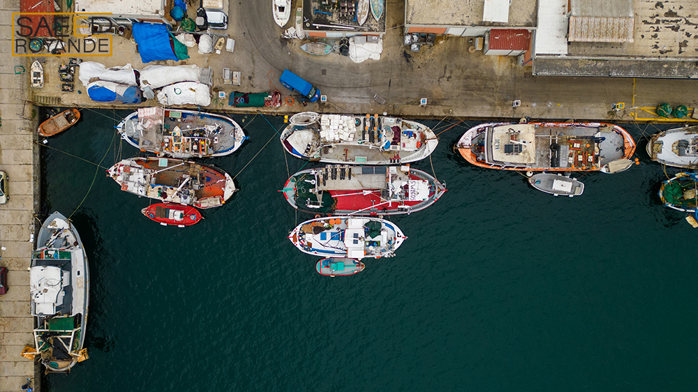 An aerial view of fishing boats in the port