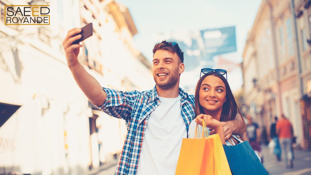 Attractive young couple doing selfi after shopping